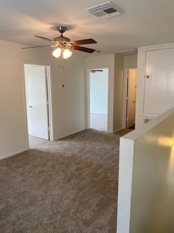 a view of a livingroom with a chandelier fan