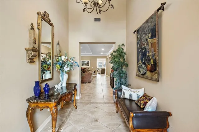 a living room with furniture large window and potted plants