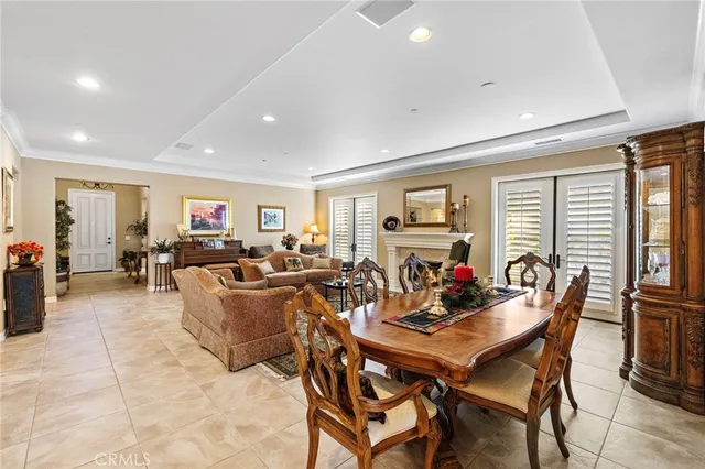 a living room with furniture fireplace and large windows