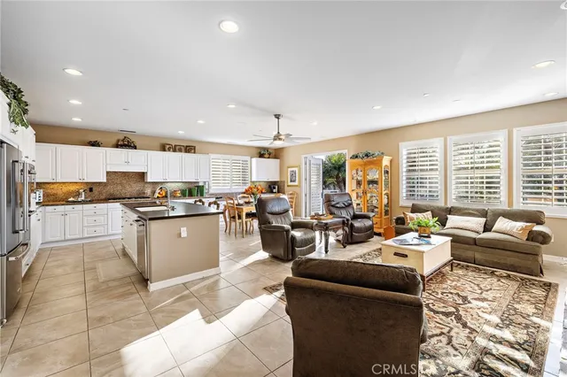 a living room with furniture fireplace and a large window
