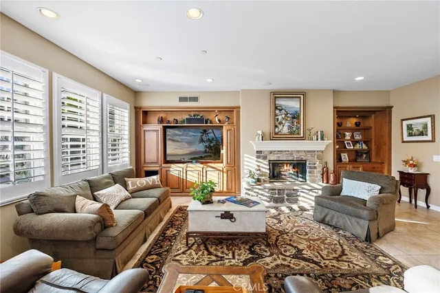 a living room with furniture kitchen view and a large window