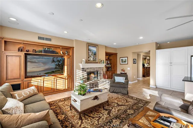 a large kitchen with kitchen island a large counter top stainless steel appliances and cabinets