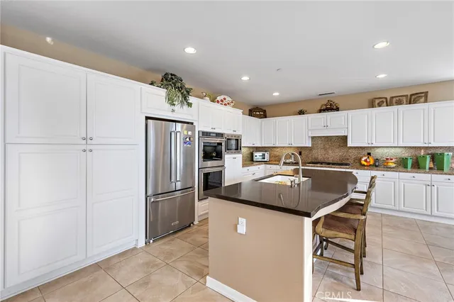 a dining room with furniture a large window and a chandelier