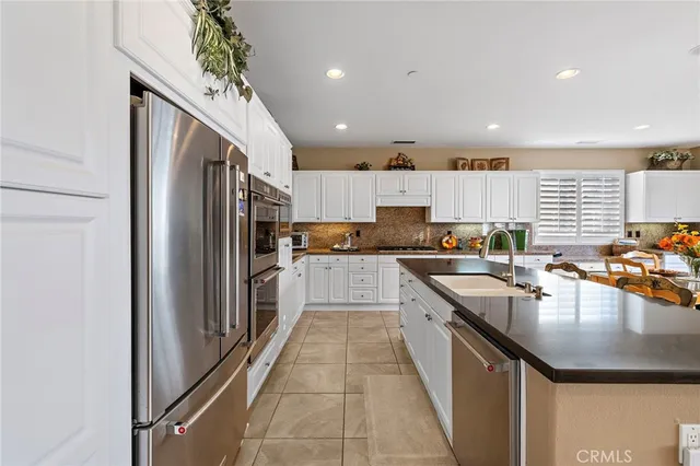 a kitchen with stainless steel appliances kitchen island granite countertop a sink and cabinets
