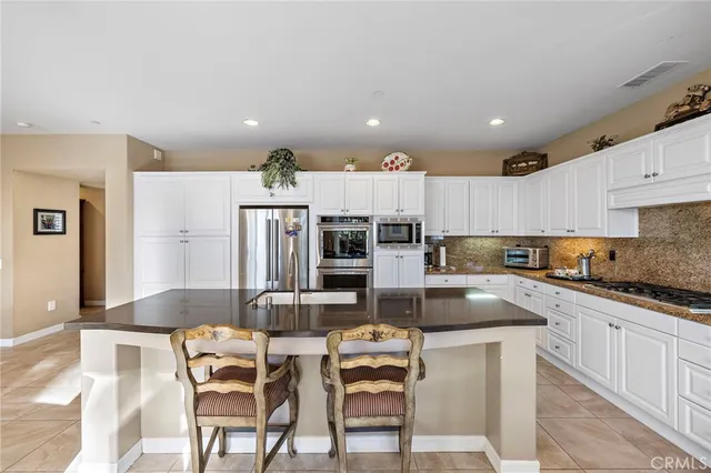a view of a chair and tables in the patio