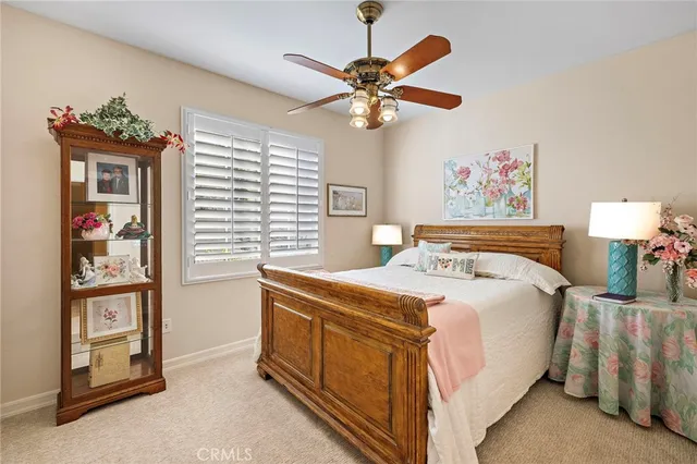a view of a house with a yard and palm trees