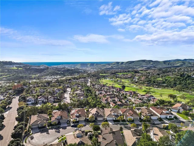 a view of swimming pool with seating area and trees in the background