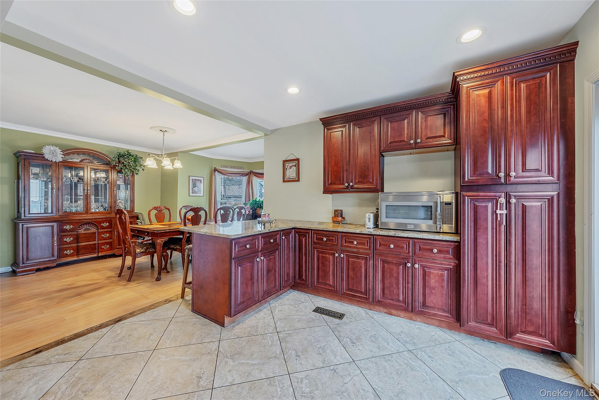 80 George Street Babylon, NY 11702 - Photo 14 of 41 a kitchen with stainless steel appliances granite countertop a refrigerator and wooden cabinets