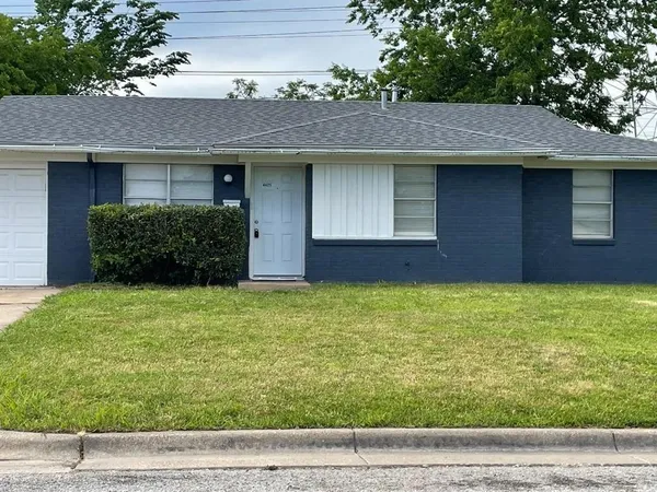 a brick house with a yard