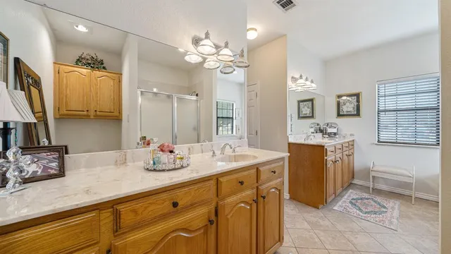 a bathroom with a granite countertop sink a mirror and a bathtub