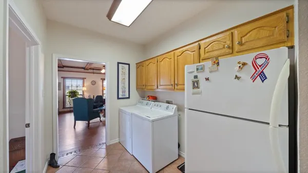 a white refrigerator freezer sitting inside of a kitchen