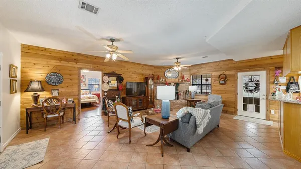 a living room with lots of furniture and chandelier
