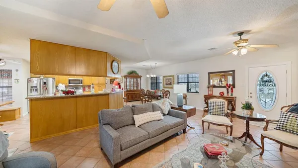 a living room with furniture and a kitchen view