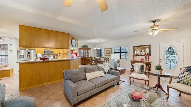 a living room with furniture and a kitchen view