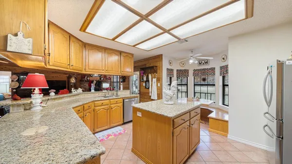a kitchen with stainless steel appliances granite countertop a sink and cabinets