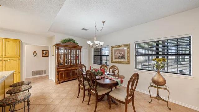 a dining room with furniture a chandelier and window