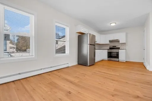 a view of a kitchen with a stove cabinets and wooden floor