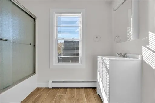 a view of a room with wooden floor and cabinet