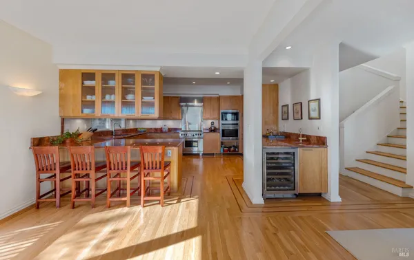 a dining room with furniture and wooden floor