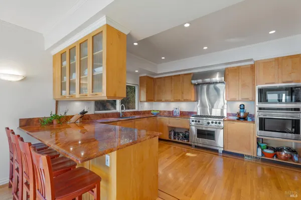 a kitchen with stainless steel appliances granite countertop a stove and a sink