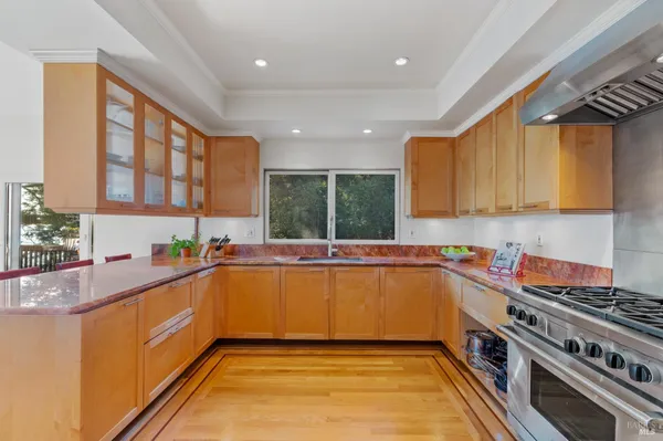 a kitchen with stainless steel appliances granite countertop a sink and cabinets