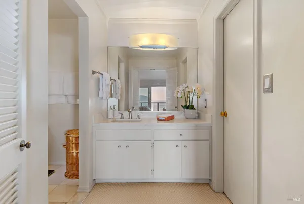 a bathroom with a sink vanity and a mirror
