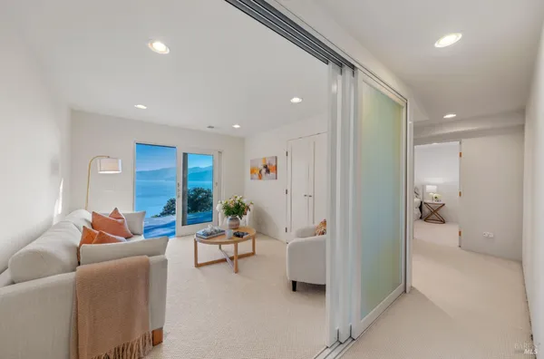 a living room with furniture and a view of bedroom