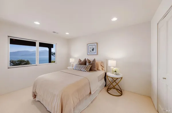 a bedroom with a bed and a painting on the wall