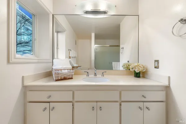 a bathroom with a double vanity sink and a mirror