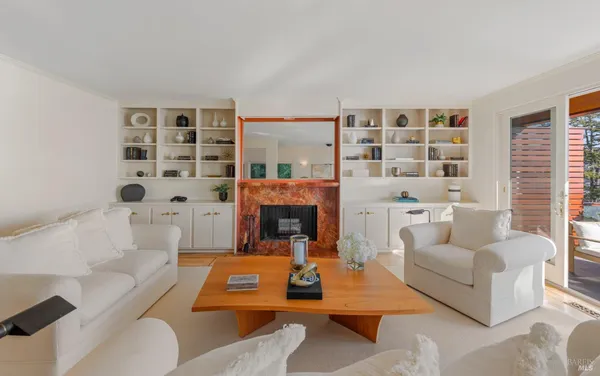 a living room with furniture and a fireplace