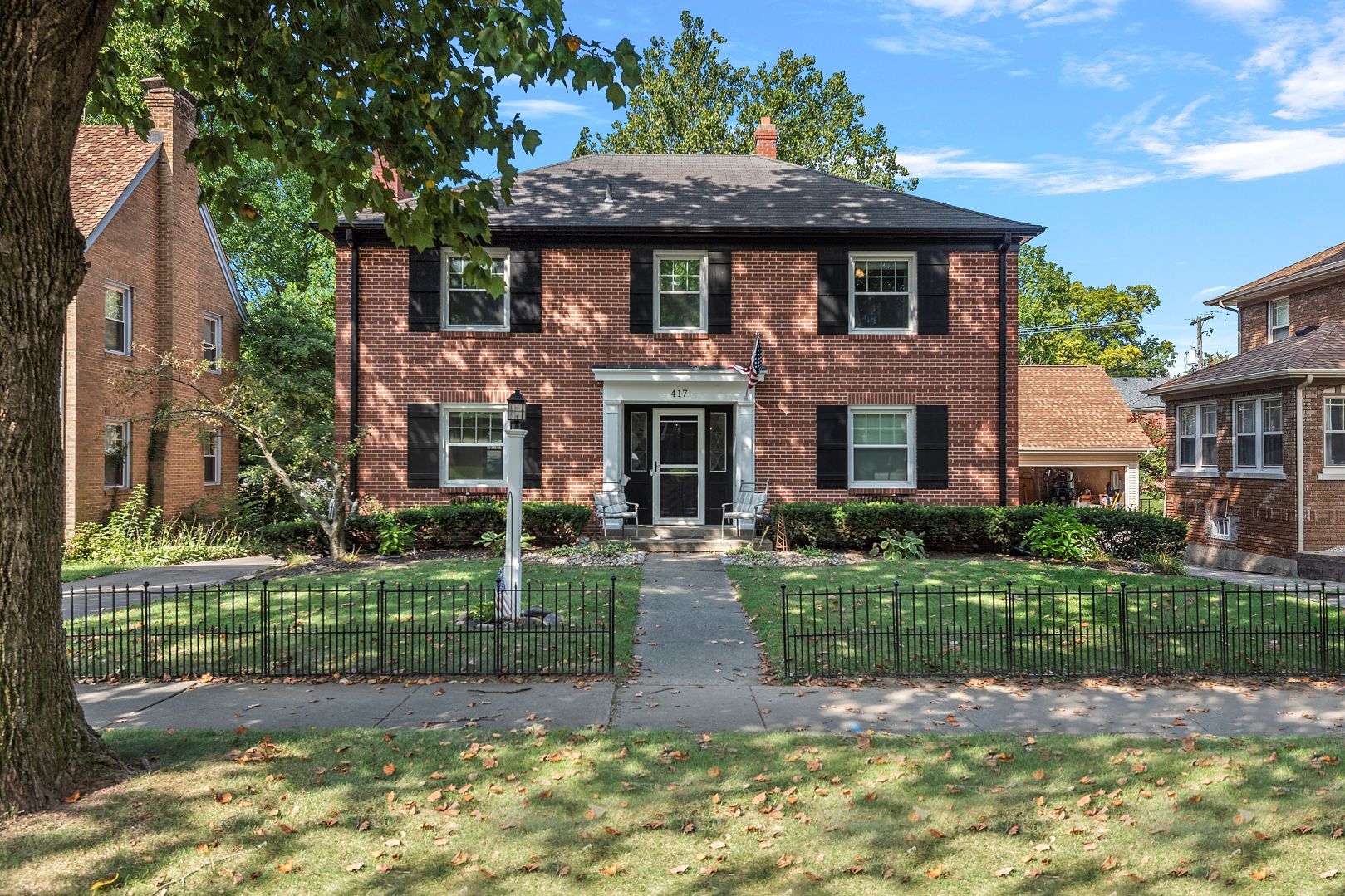 a front view of a house with a yard table and chairs