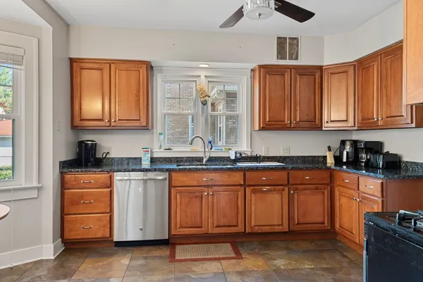 a kitchen with stainless steel appliances granite countertop a stove sink and cabinets