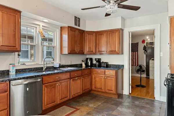 a kitchen with stainless steel appliances granite countertop a sink and cabinets