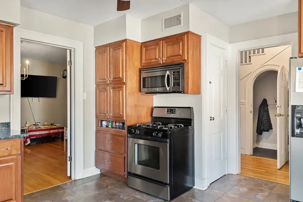 a kitchen with stainless steel appliances a stove and a refrigerator
