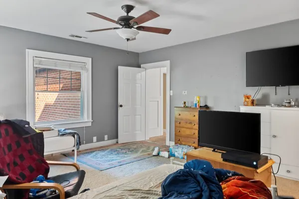 a bedroom with furniture and a flat screen tv