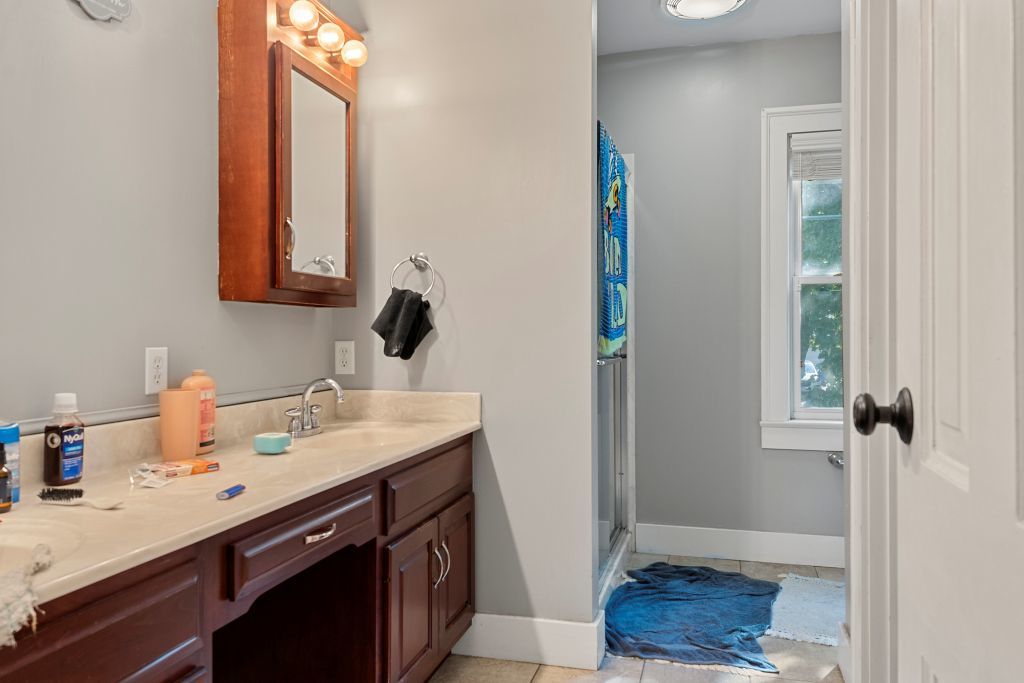 417 South Westlawn Avenue Decatur, IL 62522 - Photo 20 of 40 a bathroom with a sink vanity and a mirror