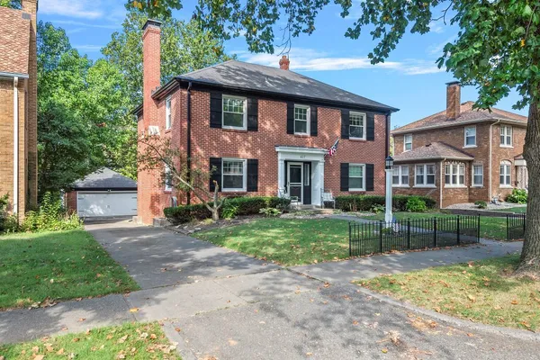a view of a brick house with a yard