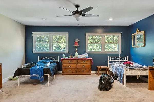 a bedroom with furniture and a window