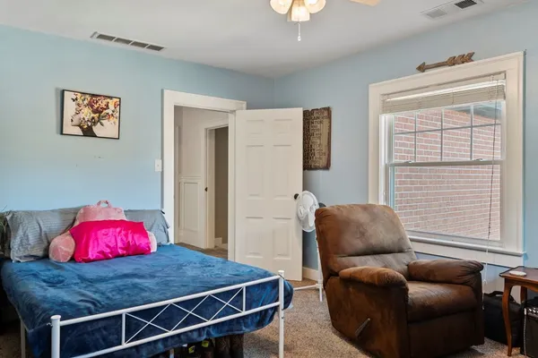 a bedroom with furniture and a window