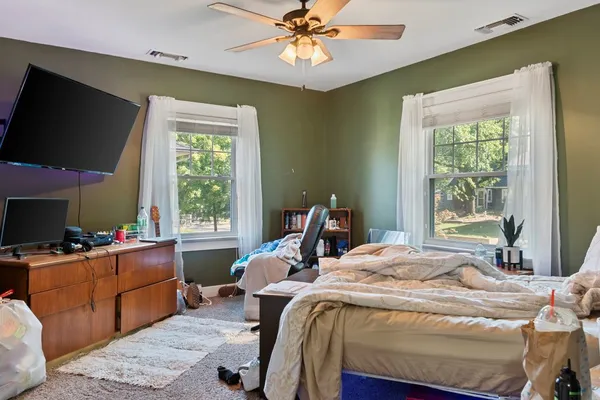 a bedroom with a bed and a flat screen tv