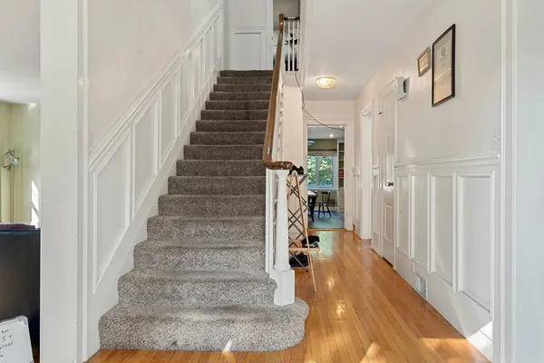 a view of entryway and hall with wooden floor
