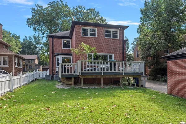 a view of house with a backyard and a patio