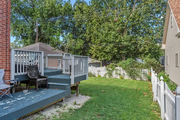 a front view of a house with a yard garden and outdoor seating