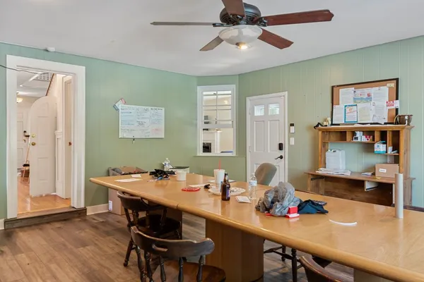 a view of a dining room with furniture and wooden floor
