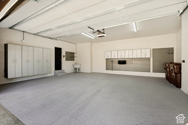 259 Twin River Loop Alpine, UT 84004 - Photo 57 of 61 Spacious garage fully painted and finished, a must-have epoxy floor, built-in cabinetry, slatted wall storage systems, and a utility sink.