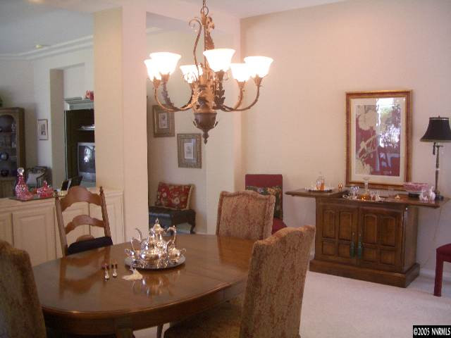 4025 Caughlin Creek Road Reno, NV 89519 - Photo 3 of 5 a living room with furniture a chandelier and a mirror
