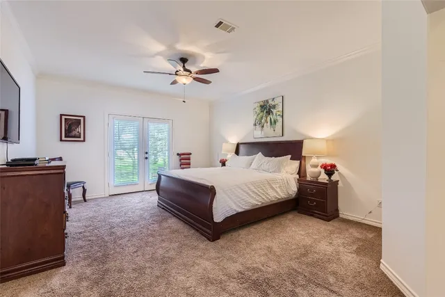 a spacious bedroom with a bed and a chandelier
