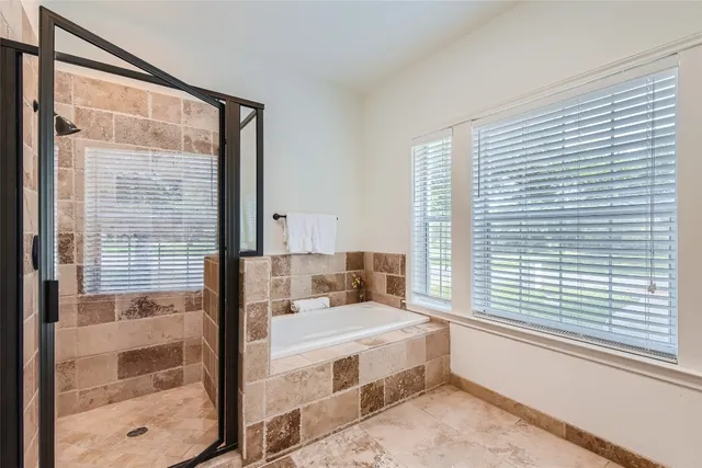 a spacious bedroom with a large bed and a window