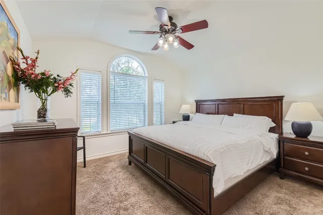 a bed room with a bed and a chandelier