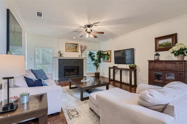 a living room with furniture fireplace and flat screen tv